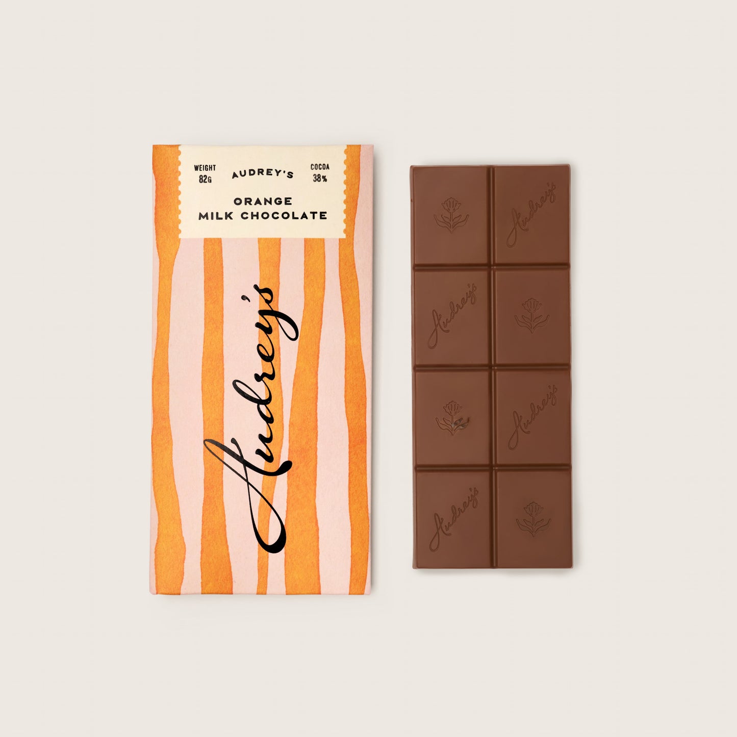 Audrey's chocolate bar packaging with a bar of chocolate on a light beige background