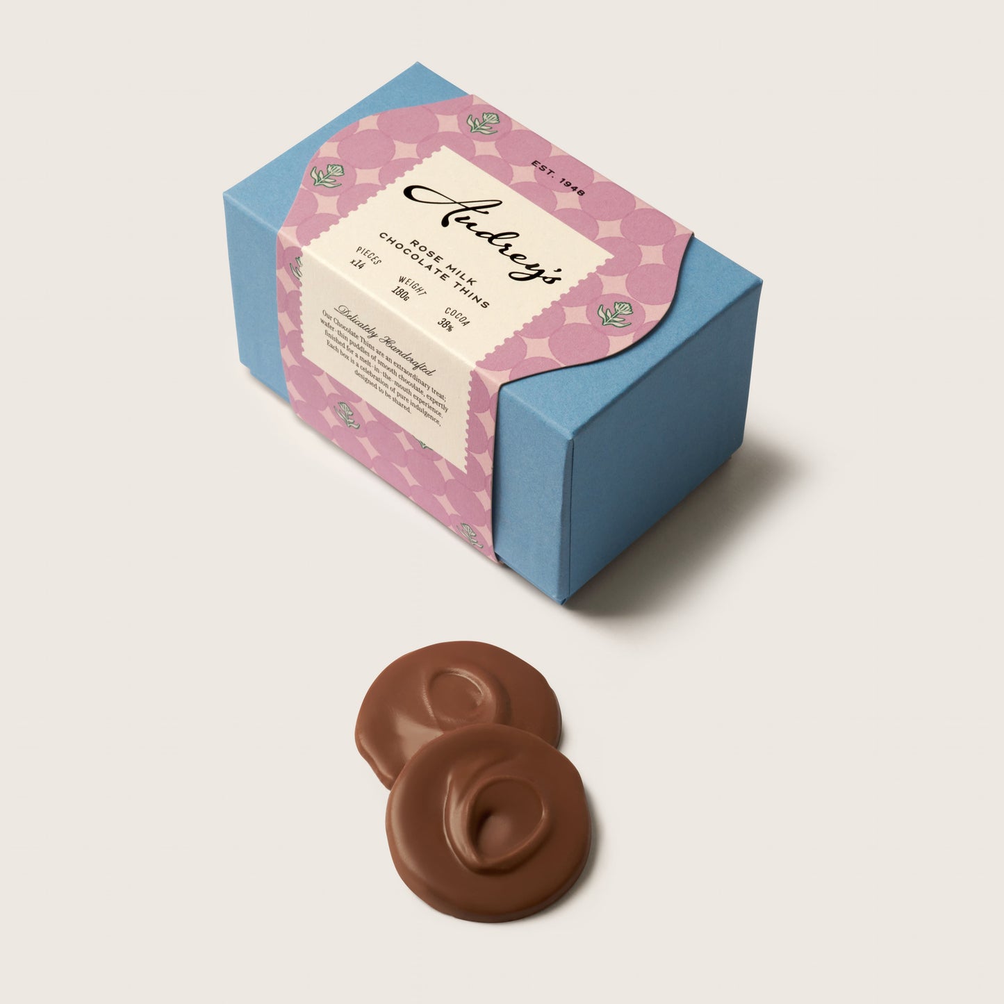 Chocolate candies with a decorative box on a light beige background