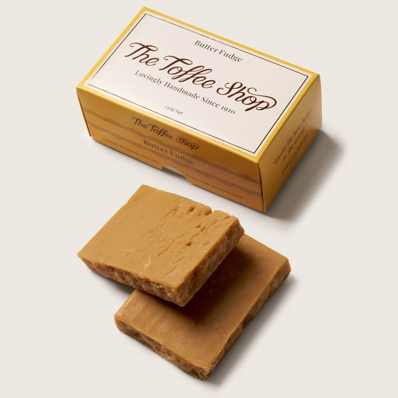 Two pieces of toffee and a box labeled 'The Toffee Shop' on a light background