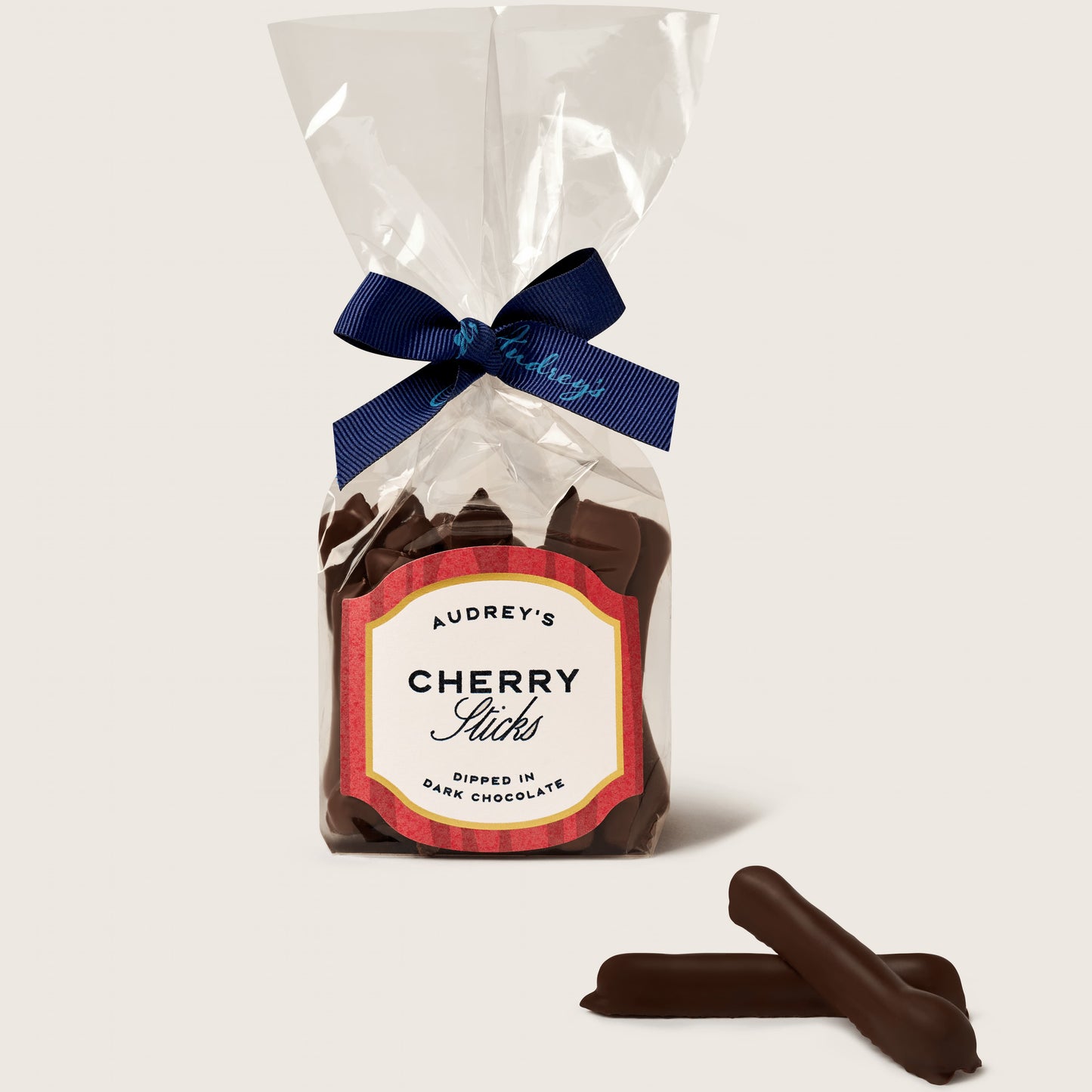 Packaged chocolate cherry sticks with a visible label on a white background