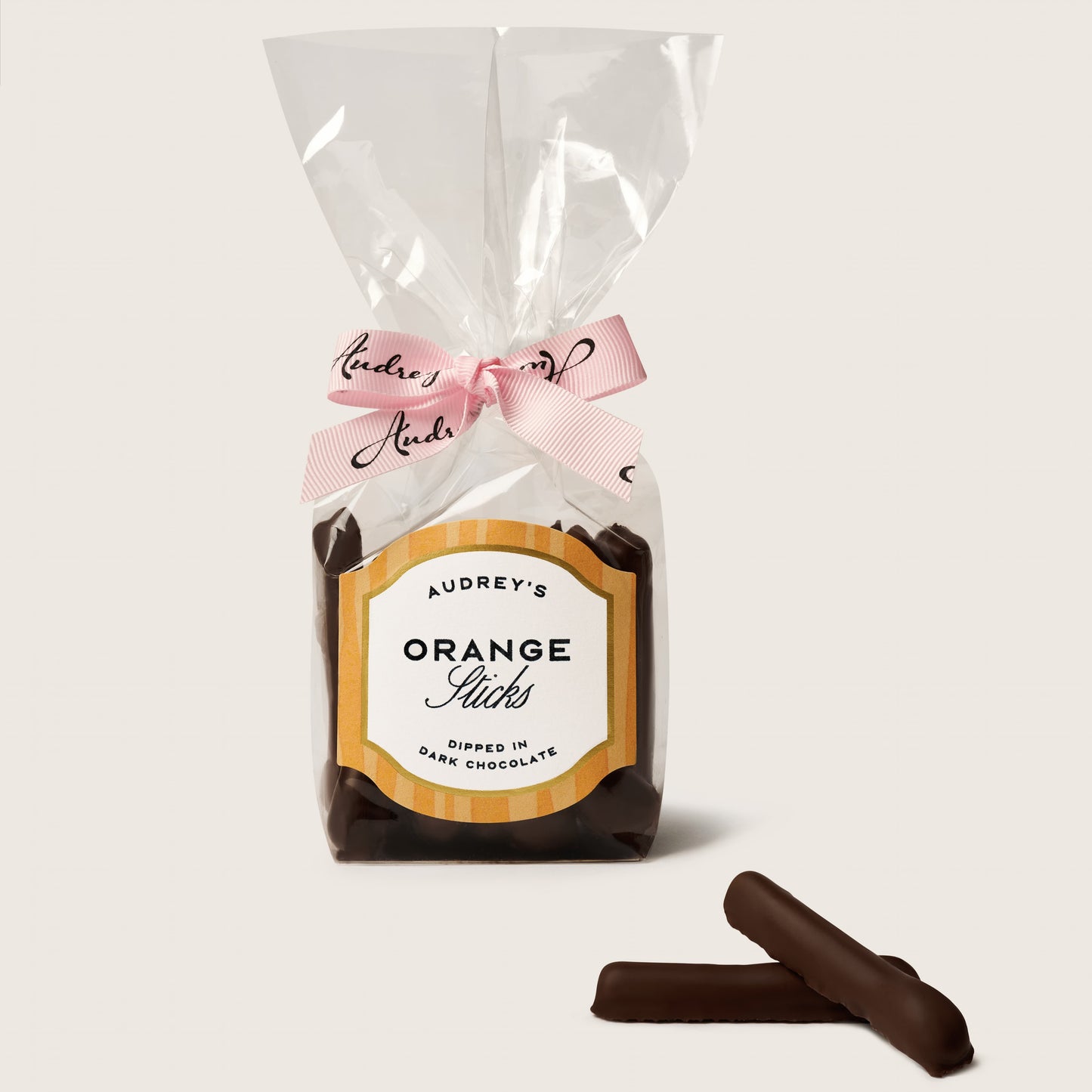 Packaged chocolate orange sticks with a decorative label on a white background