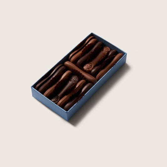 Box of chocolate cookies on a light beige background