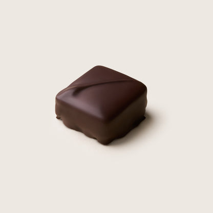 Square chocolate truffle on a light beige background