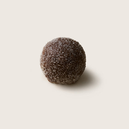 Chocolate truffle on a light beige background