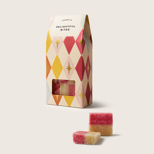 Packaged snacks with a colorful geometric box on a white background