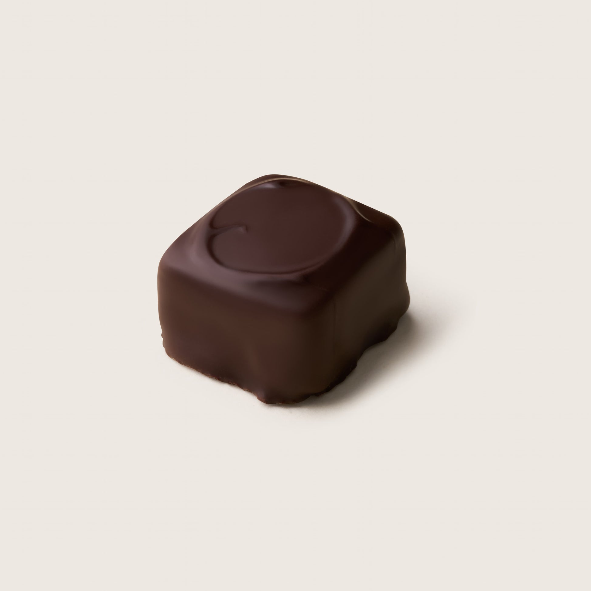 Chocolate truffle on a light beige background
