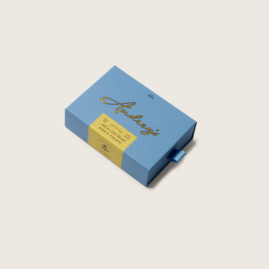 Blue gift box with gold text on a light gray background
