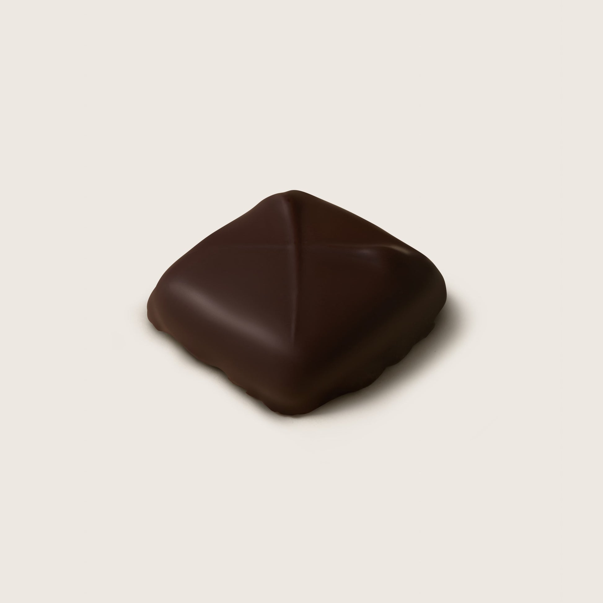 Dark chocolate truffle on a beige background