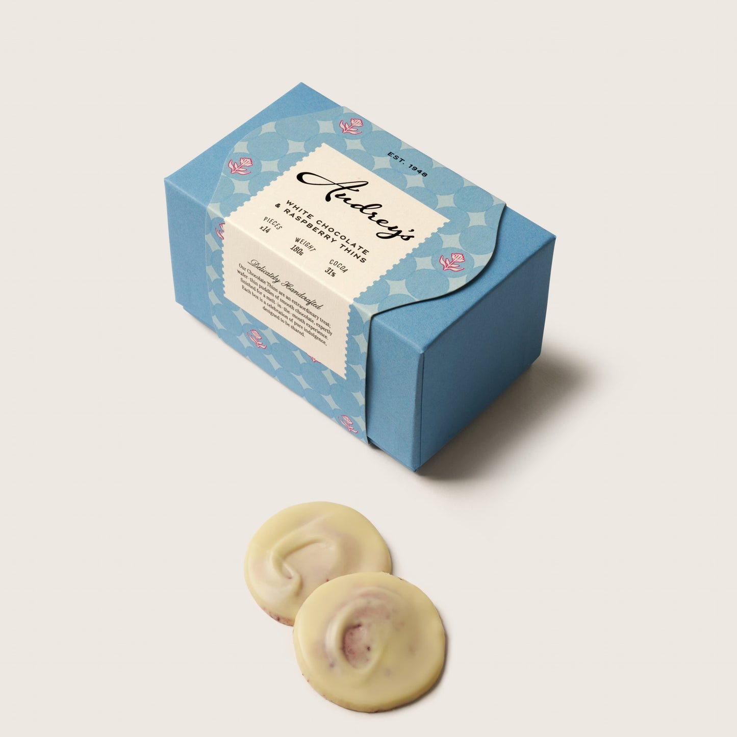 Blue gift box with a white label featuring 'And cozy' on a light gray background.